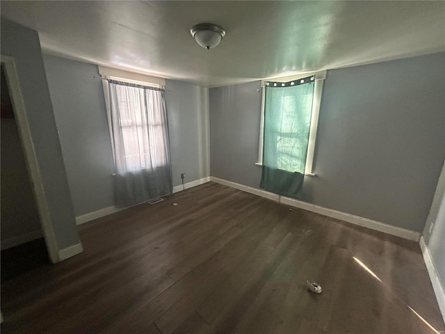 unfurnished bedroom featuring dark wood-type flooring