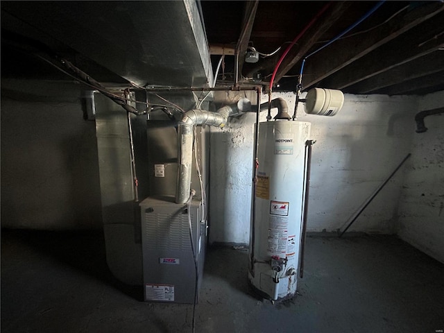 utility room featuring heating unit and gas water heater