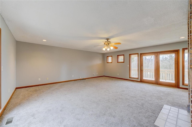 carpeted spare room with ceiling fan