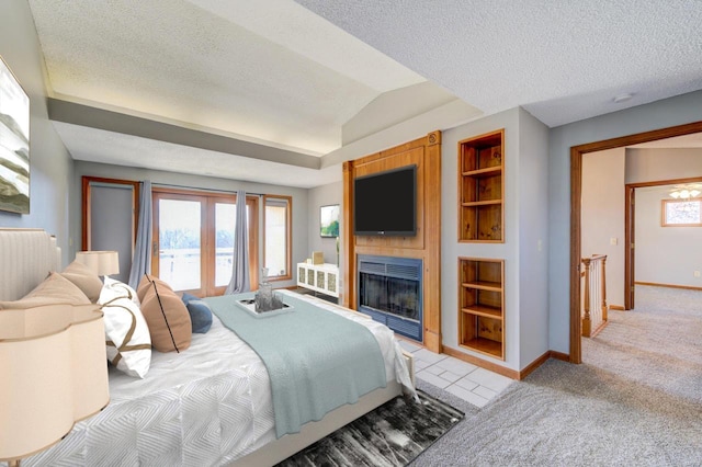 bedroom featuring french doors, a textured ceiling, light colored carpet, and vaulted ceiling