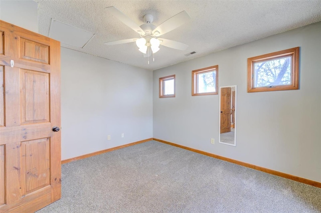 carpeted empty room featuring a textured ceiling and ceiling fan