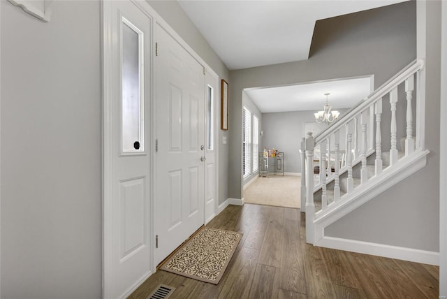 entryway featuring an inviting chandelier and hardwood / wood-style floors