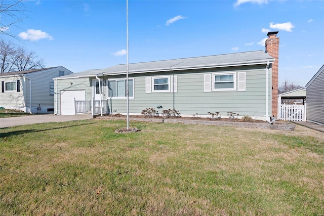 view of front of home featuring a garage and a front lawn