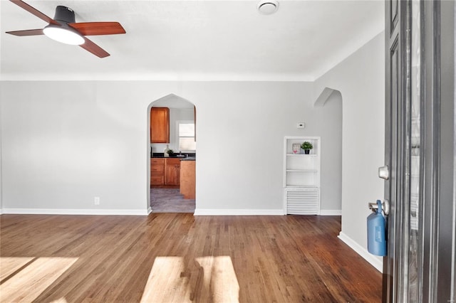 interior space featuring ceiling fan and dark wood-type flooring