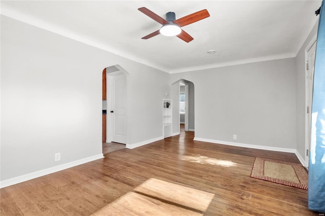 spare room with ceiling fan and hardwood / wood-style flooring