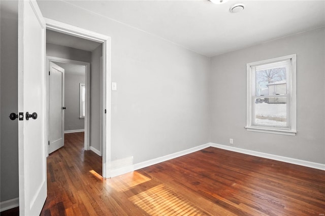 unfurnished room featuring dark hardwood / wood-style flooring