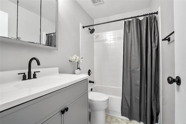 full bathroom with toilet, vanity, and shower / tub combo