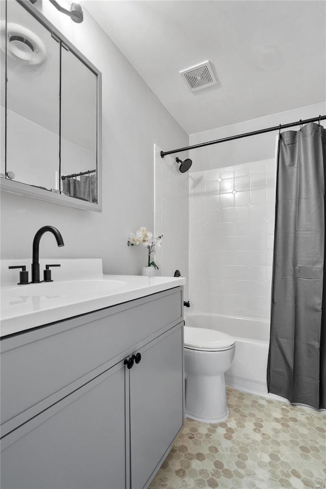 full bathroom with toilet, vanity, and shower / tub combo with curtain