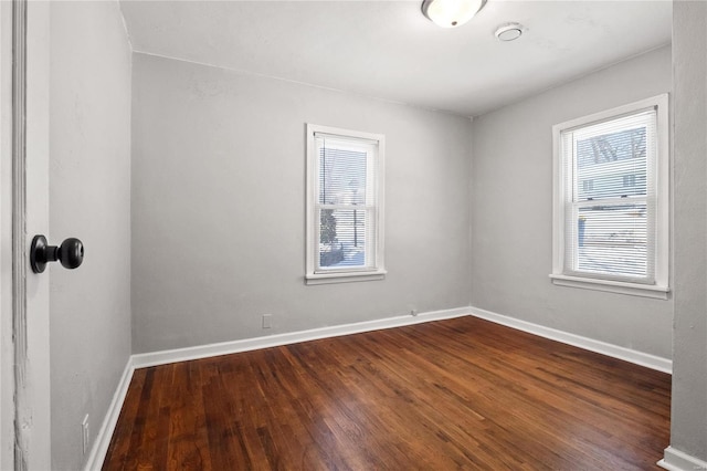 spare room featuring dark wood-type flooring