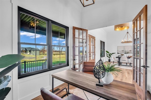 interior space featuring a chandelier and french doors