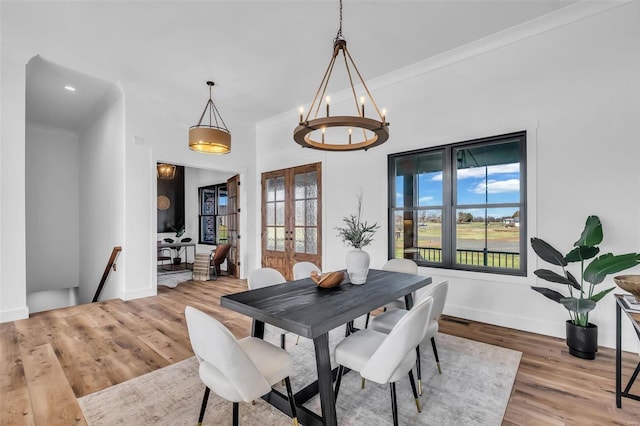 dining room featuring hardwood / wood-style floors, french doors, and crown molding