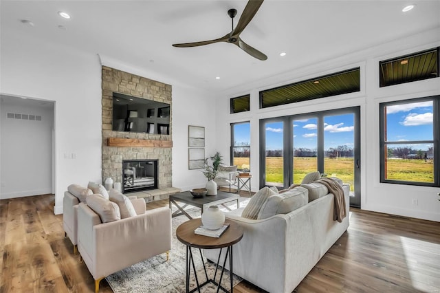 living room with a fireplace, hardwood / wood-style floors, and ceiling fan