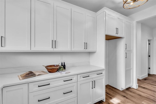 kitchen featuring white cabinetry and light wood-type flooring