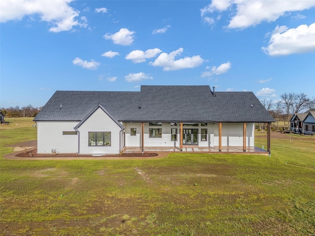 back of house featuring a lawn and a patio