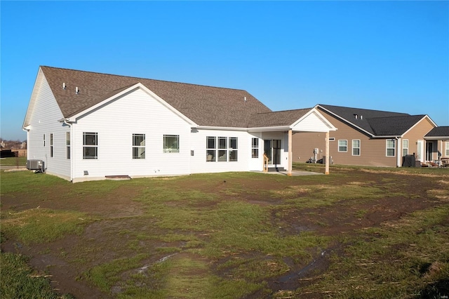 back of property featuring a yard and central air condition unit