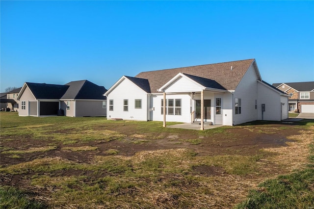 rear view of property featuring a patio area and a lawn