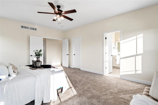 bedroom with ensuite bath, ceiling fan, and light colored carpet