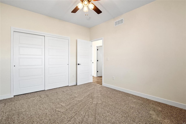 unfurnished bedroom with ceiling fan, carpet floors, and a closet