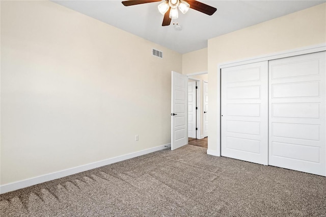 unfurnished bedroom with ceiling fan, carpet floors, and a closet