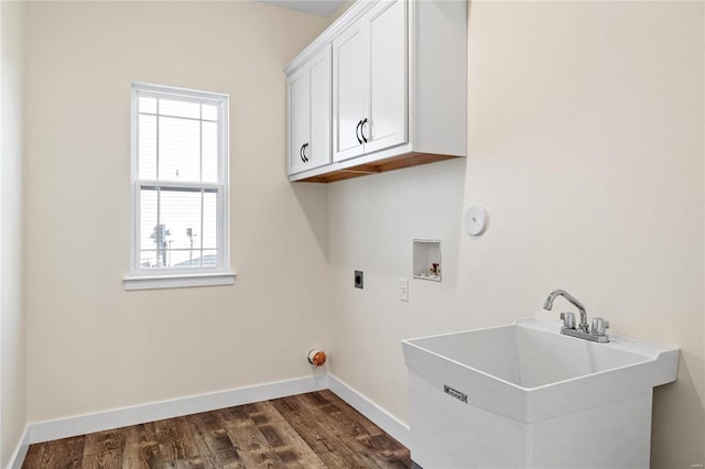 washroom featuring electric dryer hookup, cabinets, dark wood-type flooring, sink, and washer hookup