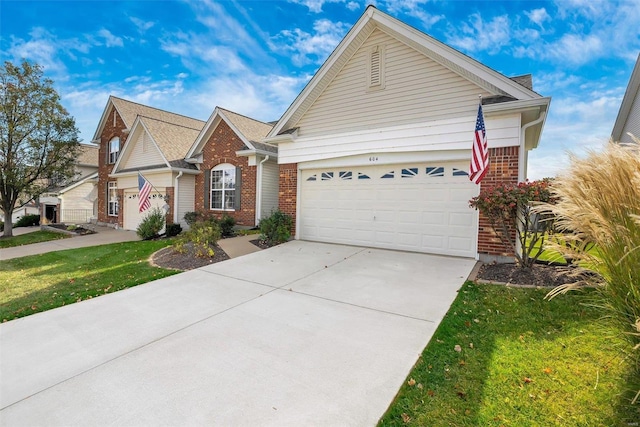 view of front of property featuring a front lawn and a garage