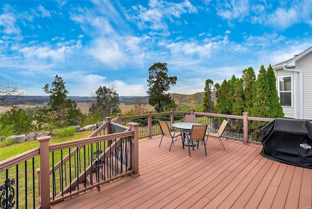 wooden deck featuring a mountain view and grilling area