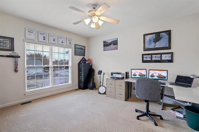 office space featuring light carpet and ceiling fan