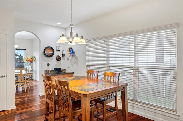 dining room featuring dark hardwood / wood-style flooring and a chandelier