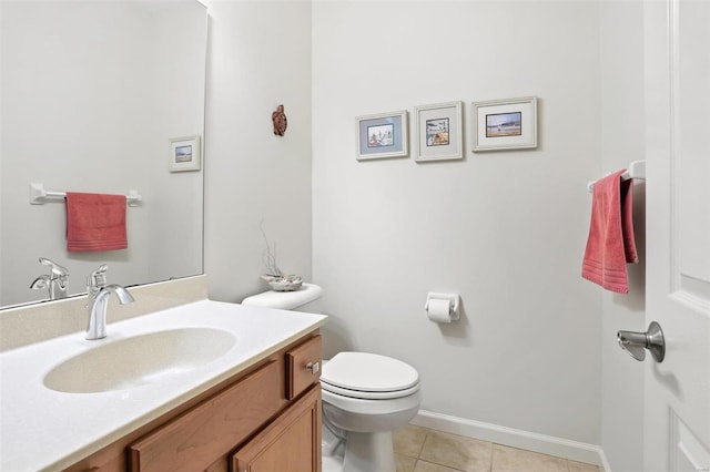 bathroom featuring tile patterned floors, vanity, and toilet