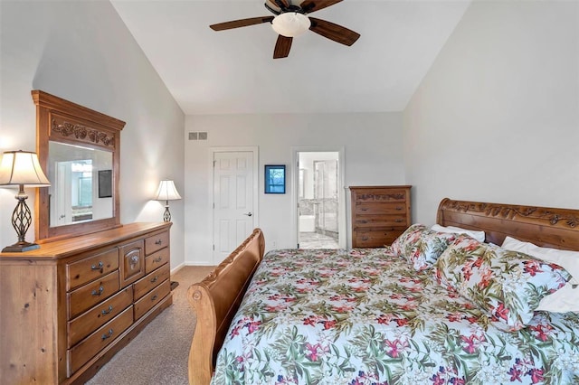 carpeted bedroom with ceiling fan, lofted ceiling, and ensuite bath