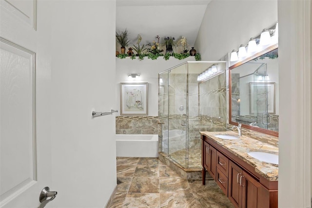 bathroom with vanity, separate shower and tub, and vaulted ceiling