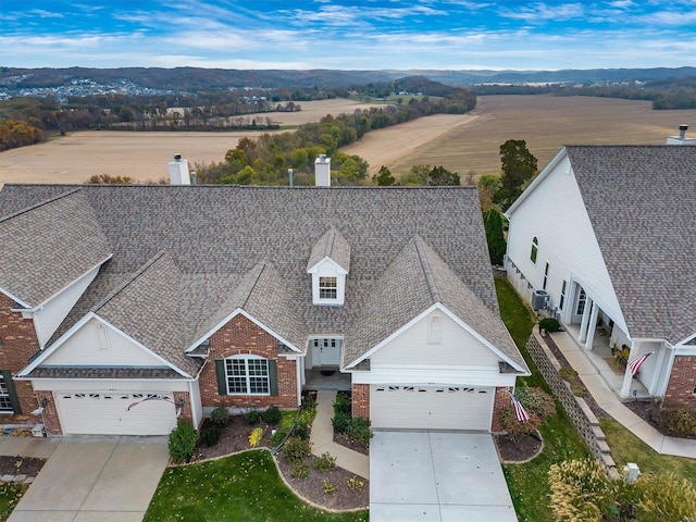 birds eye view of property with a rural view