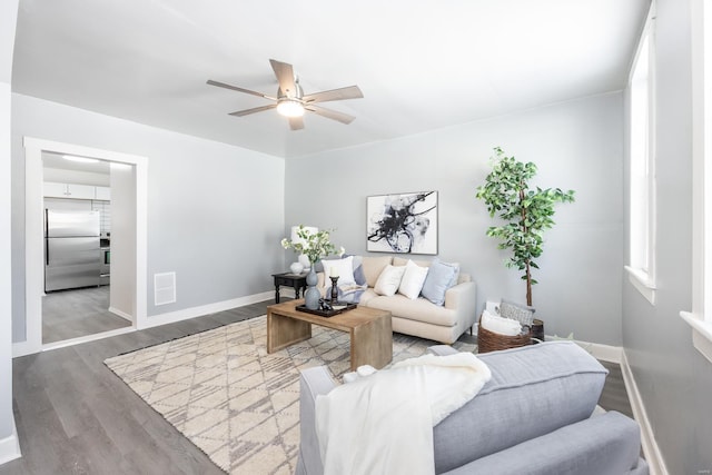 living room with hardwood / wood-style floors and ceiling fan