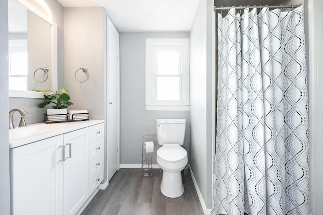 bathroom with toilet, hardwood / wood-style floors, vanity, and a shower with shower curtain