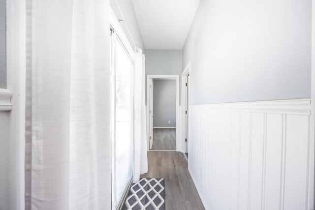 hallway with hardwood / wood-style floors