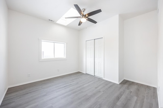 unfurnished bedroom with a closet, light hardwood / wood-style flooring, and ceiling fan