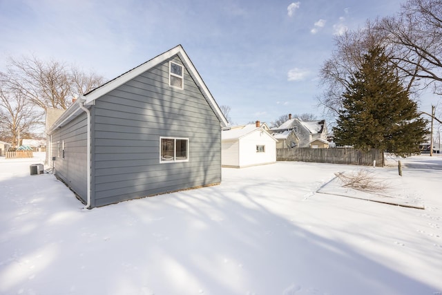 view of snowy exterior featuring central AC unit