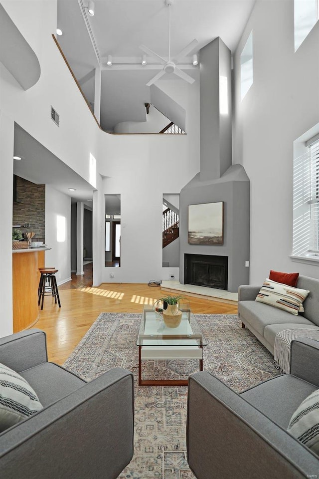 living room featuring hardwood / wood-style floors and ceiling fan