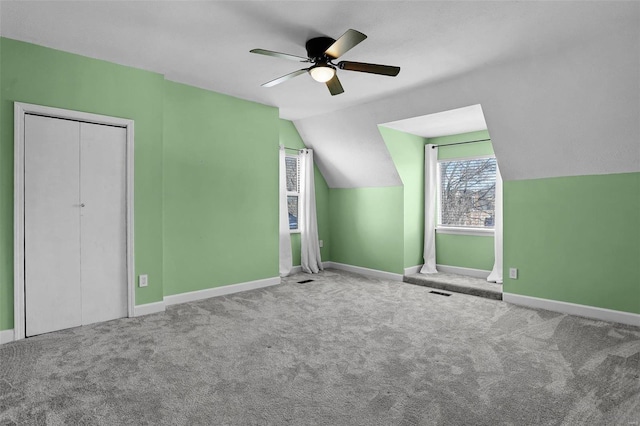 bonus room featuring lofted ceiling, ceiling fan, and carpet