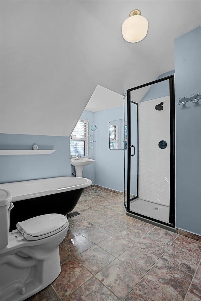 bathroom featuring lofted ceiling, toilet, and a shower with shower door