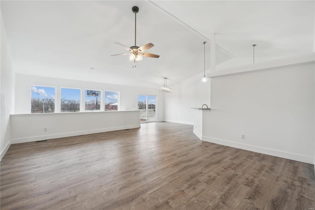 unfurnished living room with high vaulted ceiling, wood-type flooring, and ceiling fan with notable chandelier