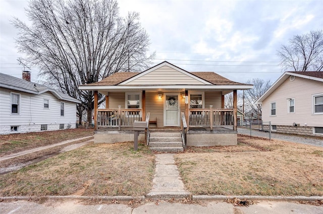 bungalow-style home with a front lawn and a porch