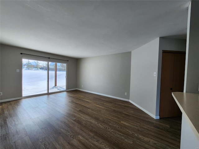 spare room with dark hardwood / wood-style flooring