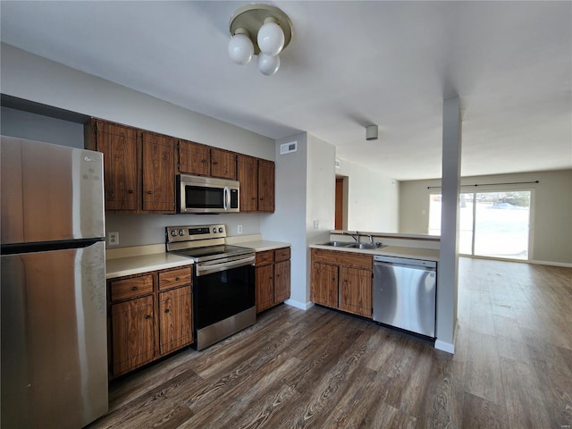 kitchen featuring sink, dark hardwood / wood-style floors, and appliances with stainless steel finishes