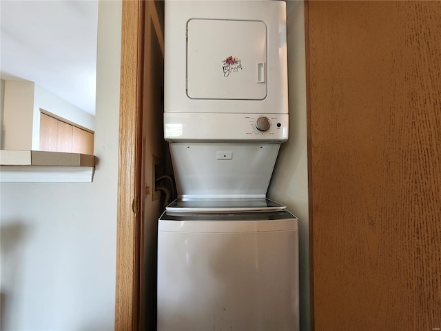 laundry area featuring stacked washer and clothes dryer