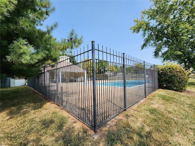 view of pool with a lawn