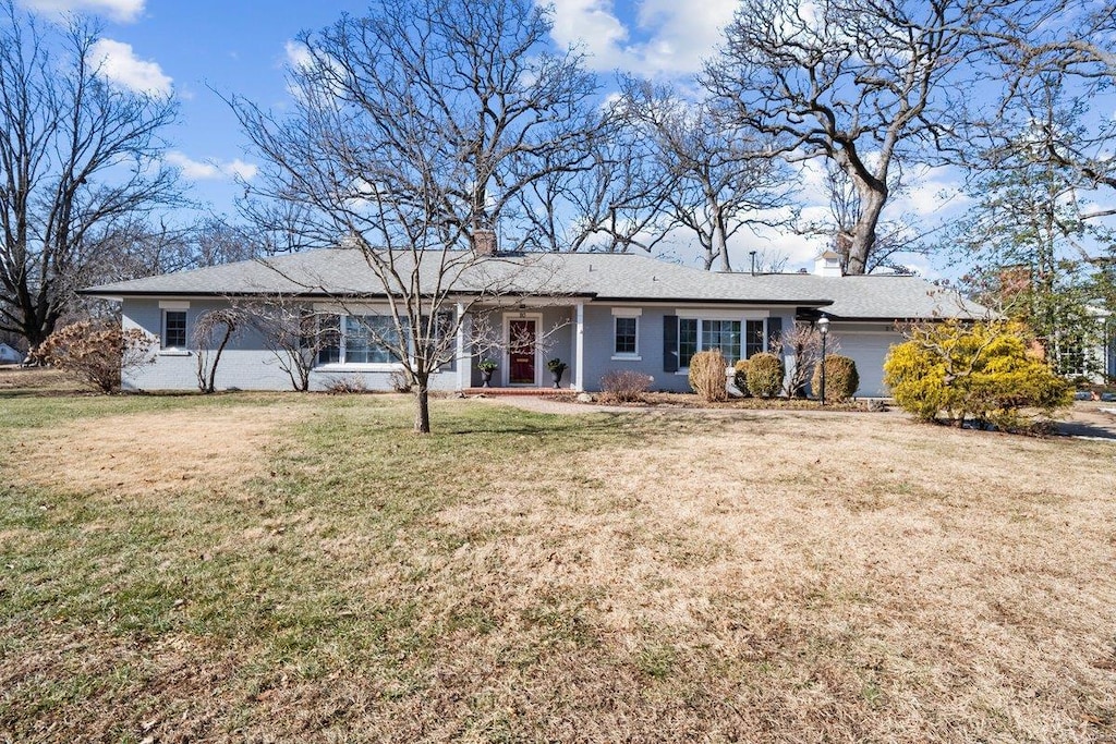 rear view of property featuring a yard