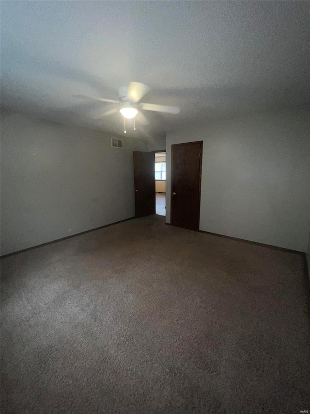 unfurnished room with ceiling fan and carpet floors