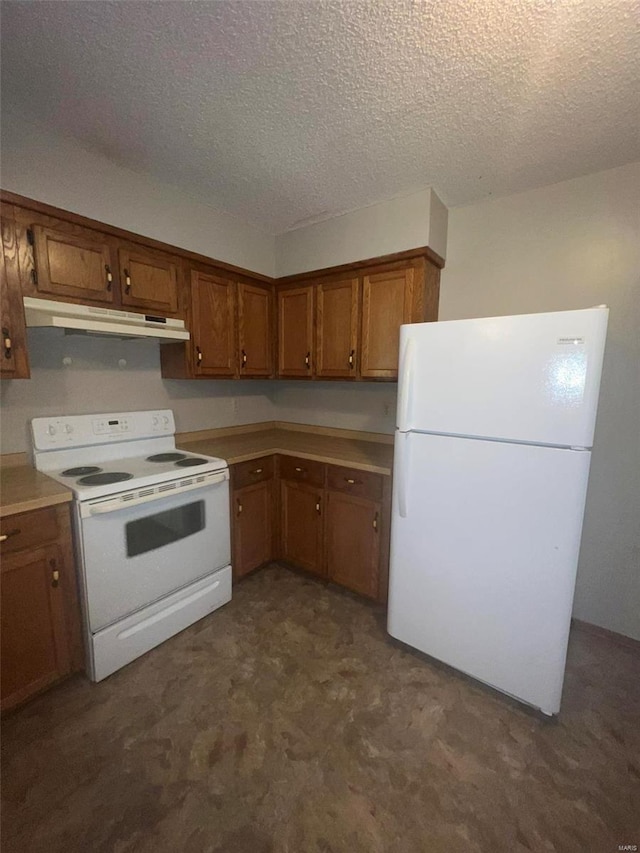 kitchen featuring a textured ceiling and white appliances