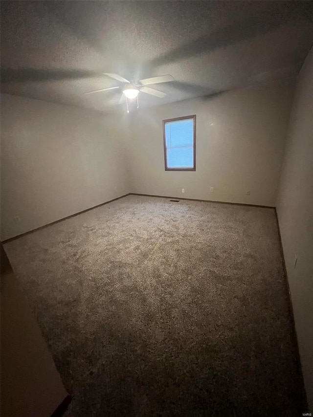 empty room featuring ceiling fan and a textured ceiling